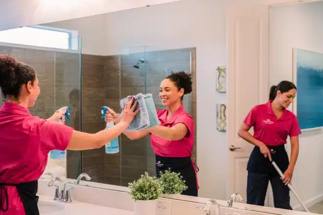 Molly Maid pros cleaning bathroom