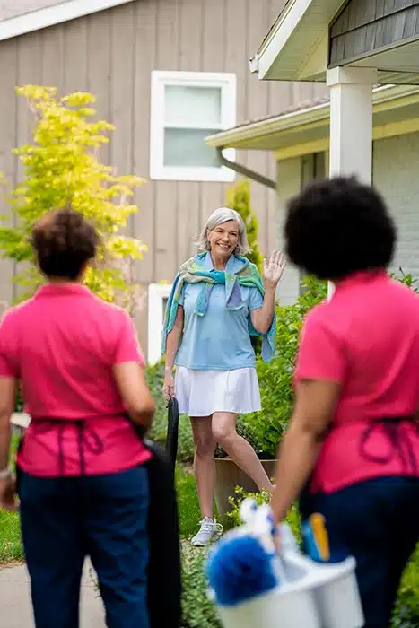Molly Maid professionals greeting customer before a recurring cleaning service appointment.
